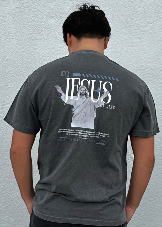 Person wearing a gray t-shirt with 'Jesus Our King' graphic on the back against a light gray background