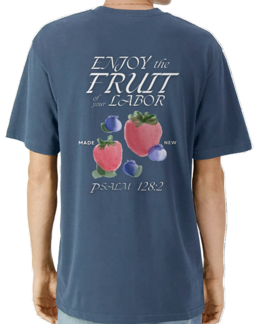 Man wearing a blue t-shirt with fruit illustration and text on the back